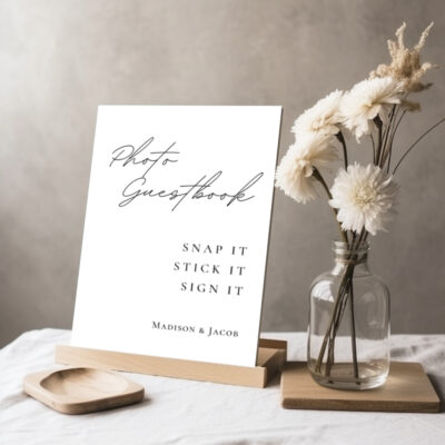 Editable Canva photo guestbook sign in Simple Script wedding style shown in tabletop display