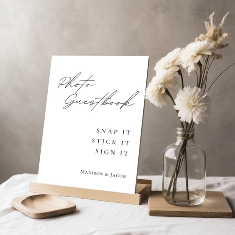 Editable Canva photo guestbook sign in Simple Script wedding style shown in tabletop display